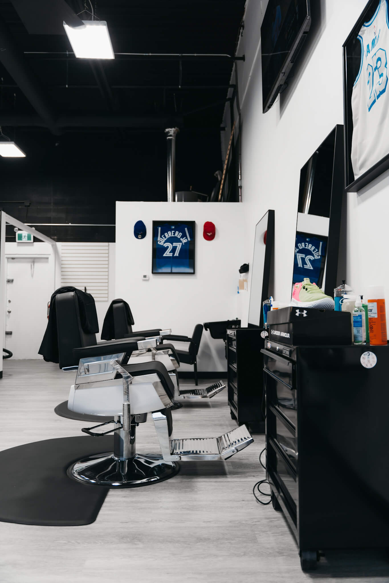 Macleod Trail Barbers Barbershop chairs sideview facing towards the back of the barbershop.